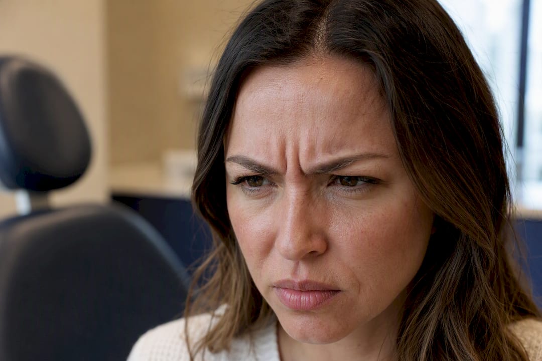 Close-up of woman frowning showing muscle movement