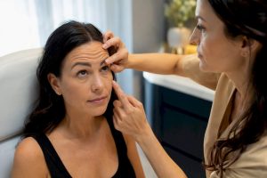 Nurse assessing forehead movement before Botox