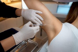 Nurse performing precise underarm Botox injections