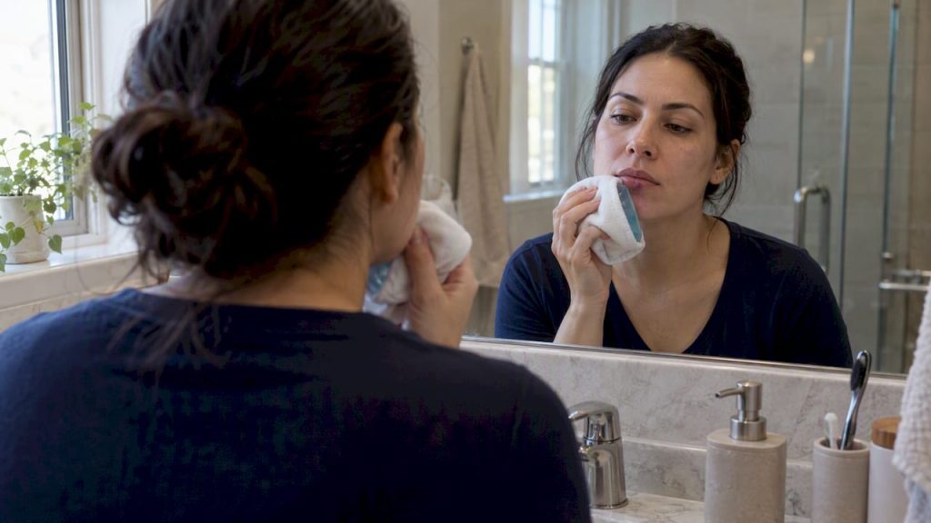 Woman gently cooling a bruised lip